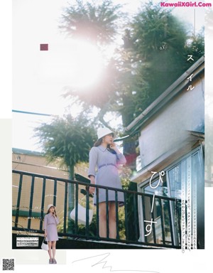 A woman in a white dress is posing for a magazine.