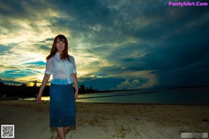 A woman in a blue bra posing for a picture.