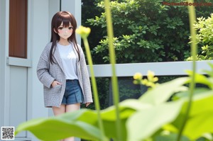 A woman standing in front of a sliding glass door.