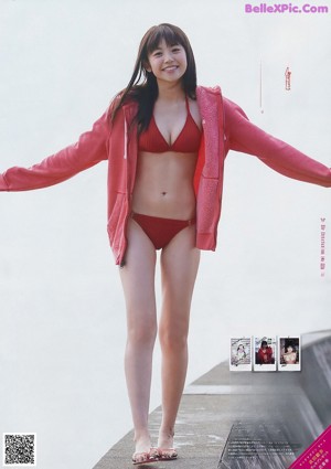 A young woman laying on the floor with her hands outstretched.