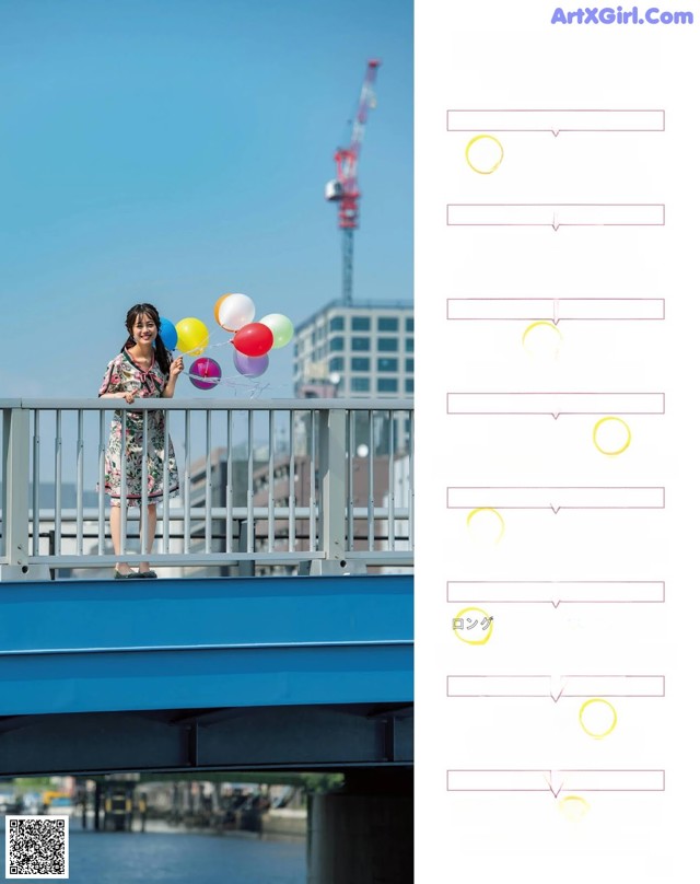 A woman standing on a bridge holding a bunch of balloons.