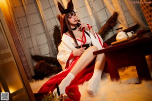 A woman in a bunny costume sitting on a chair.