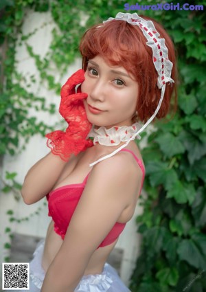 A woman in a red and white lingerie posing for a picture.