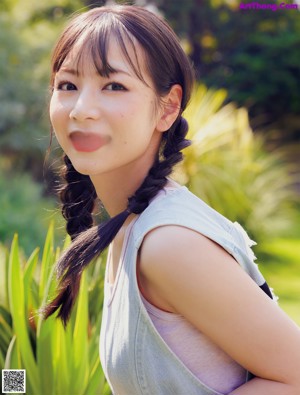 A woman with long brown hair is posing for a picture.