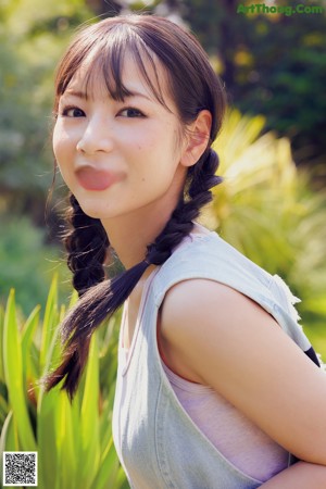 A woman in a white shirt and brown skirt posing for a magazine.