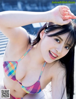 A woman in a colorful bikini posing for the camera.