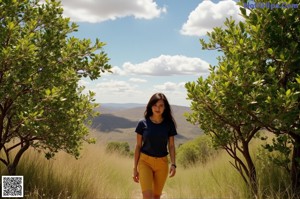A woman in a white top and pink skirt posing for a picture.